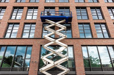 Maintenance,Workers,Are,Repairing,A,Modern,Building,Facade,From,An